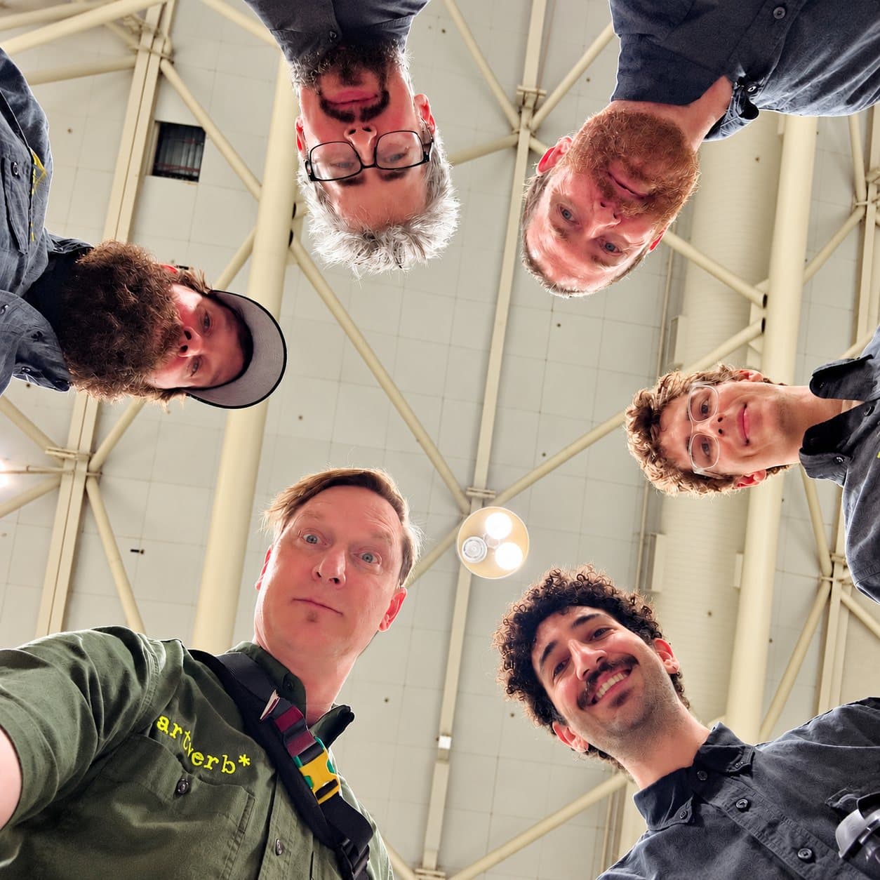 The green team looking down into the camera