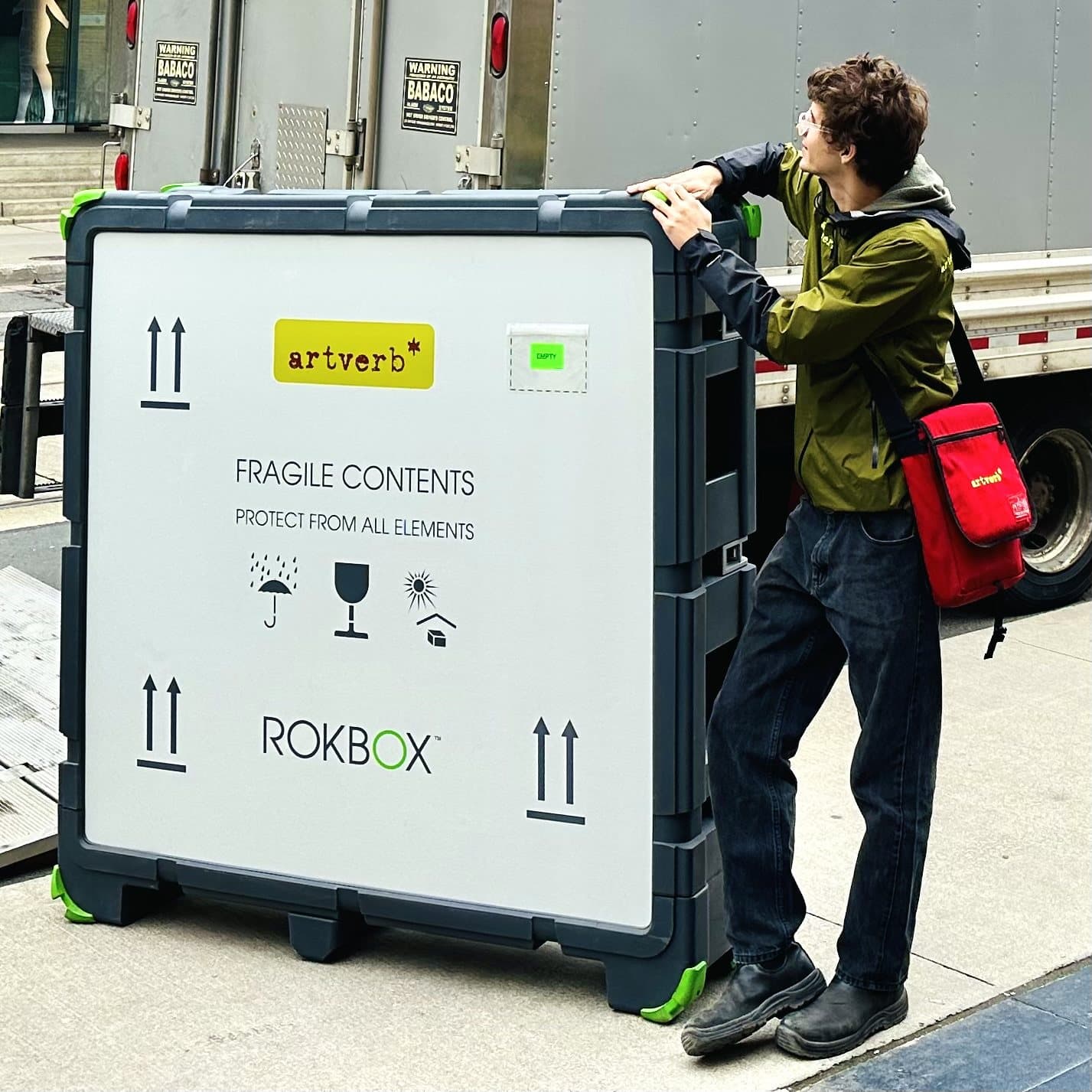 A crew member steadying a ROKBOX MEDIUM beside the truck