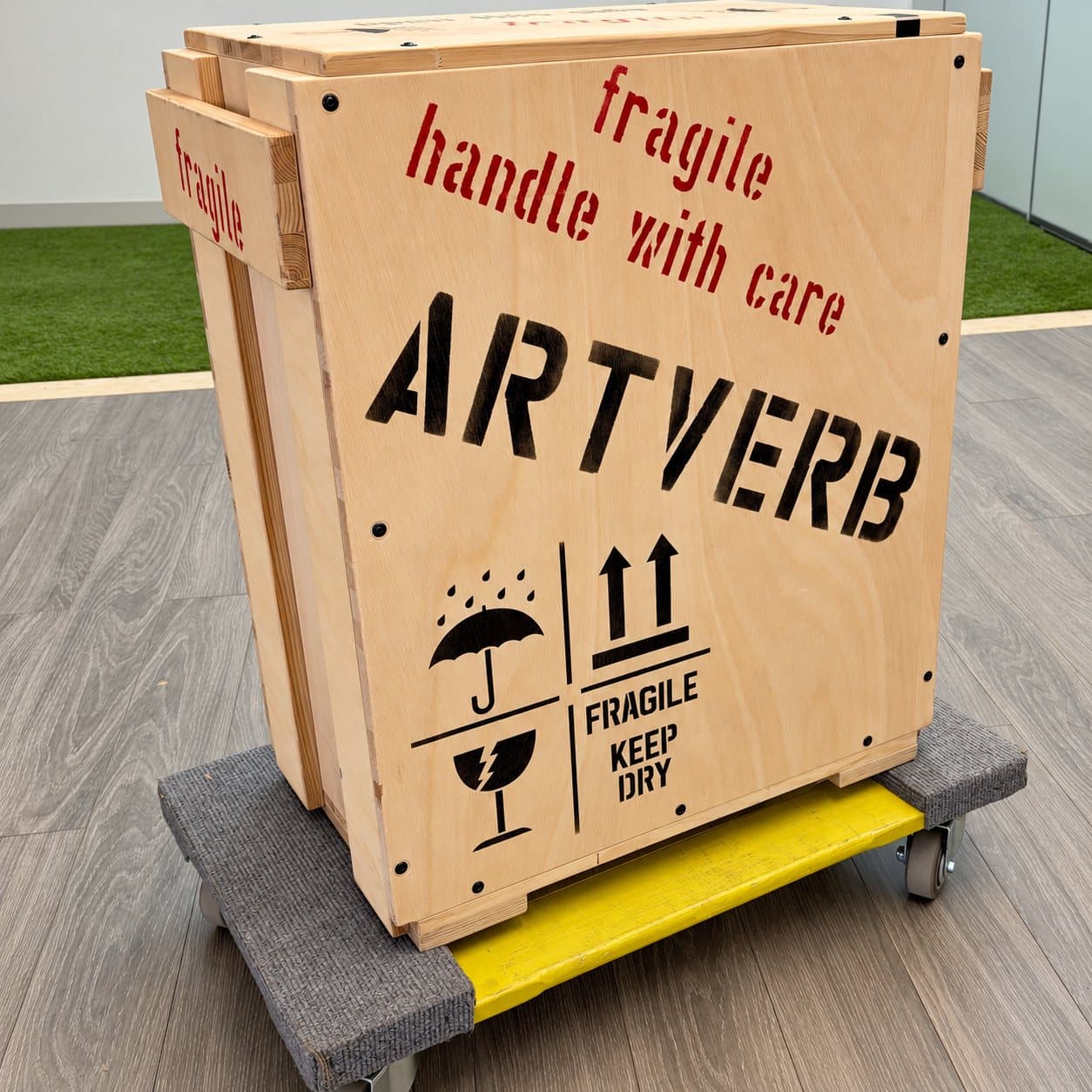 A FRAGILE HANDLE WITH CARE ArtVerb crate on a moving dolly