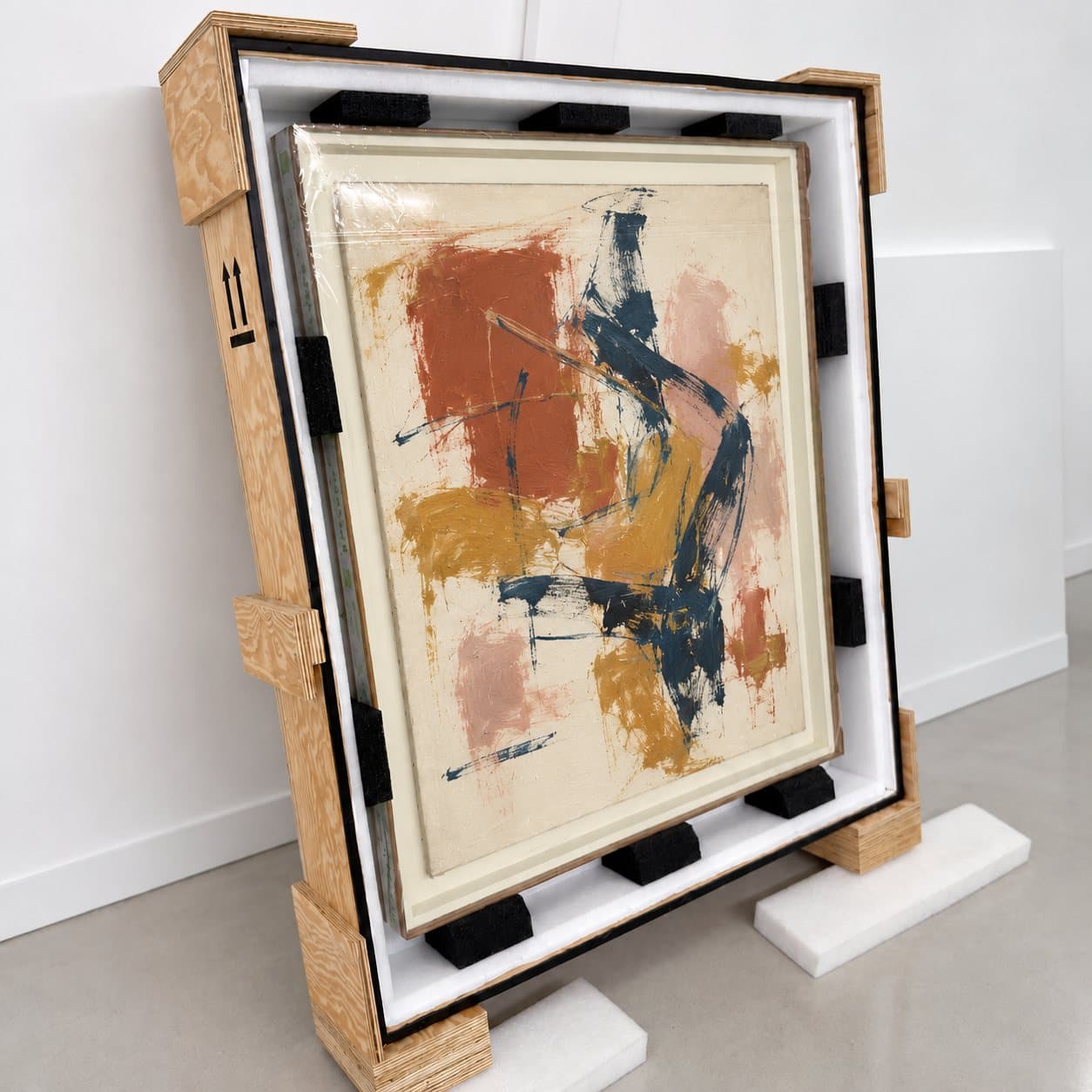 A framed painting seated in a foam-lined crate