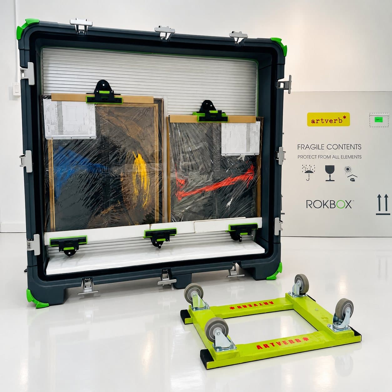 An open ROKBOX with packed works and its rolling dolly