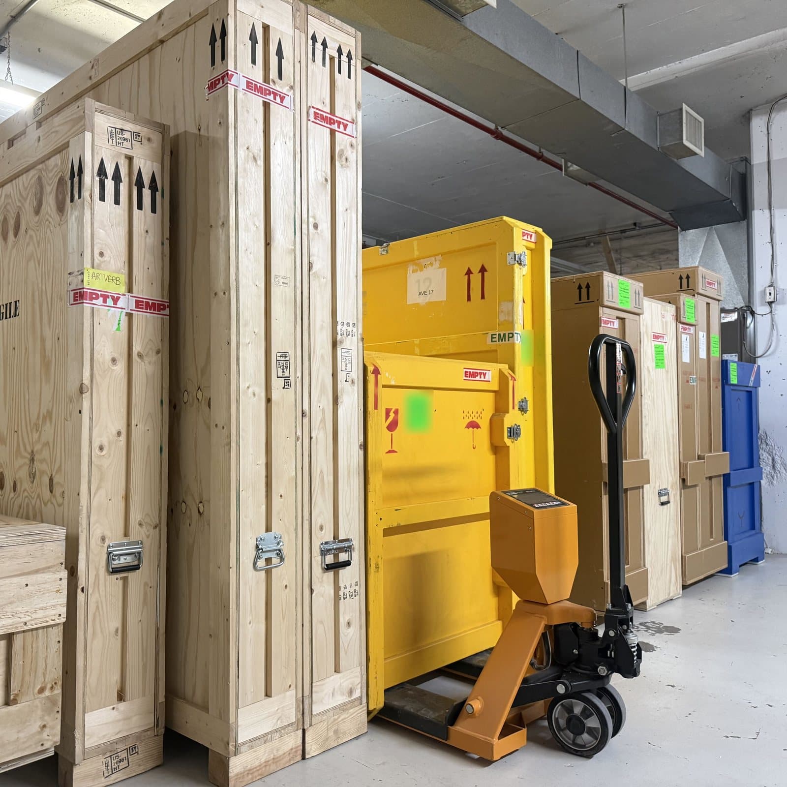Empty crates and a pallet scale stored between shipments